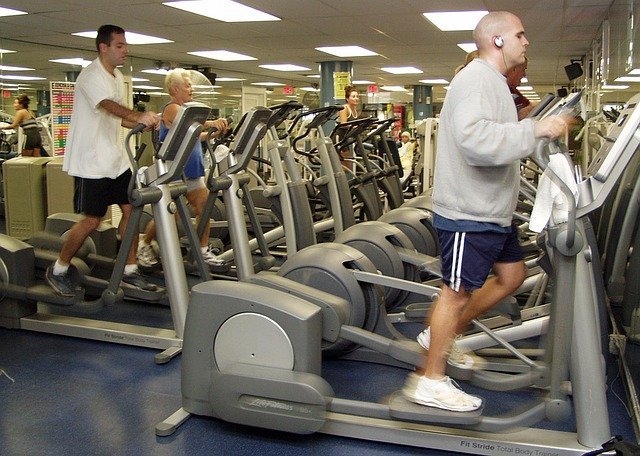 People Working Out On Ellipticals At Gym