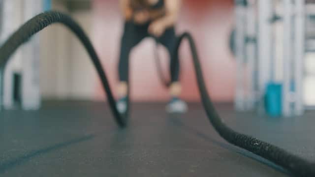 a person training with battle ropes