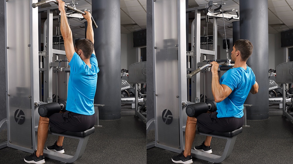 man in blue doing close grip lat pulldowns