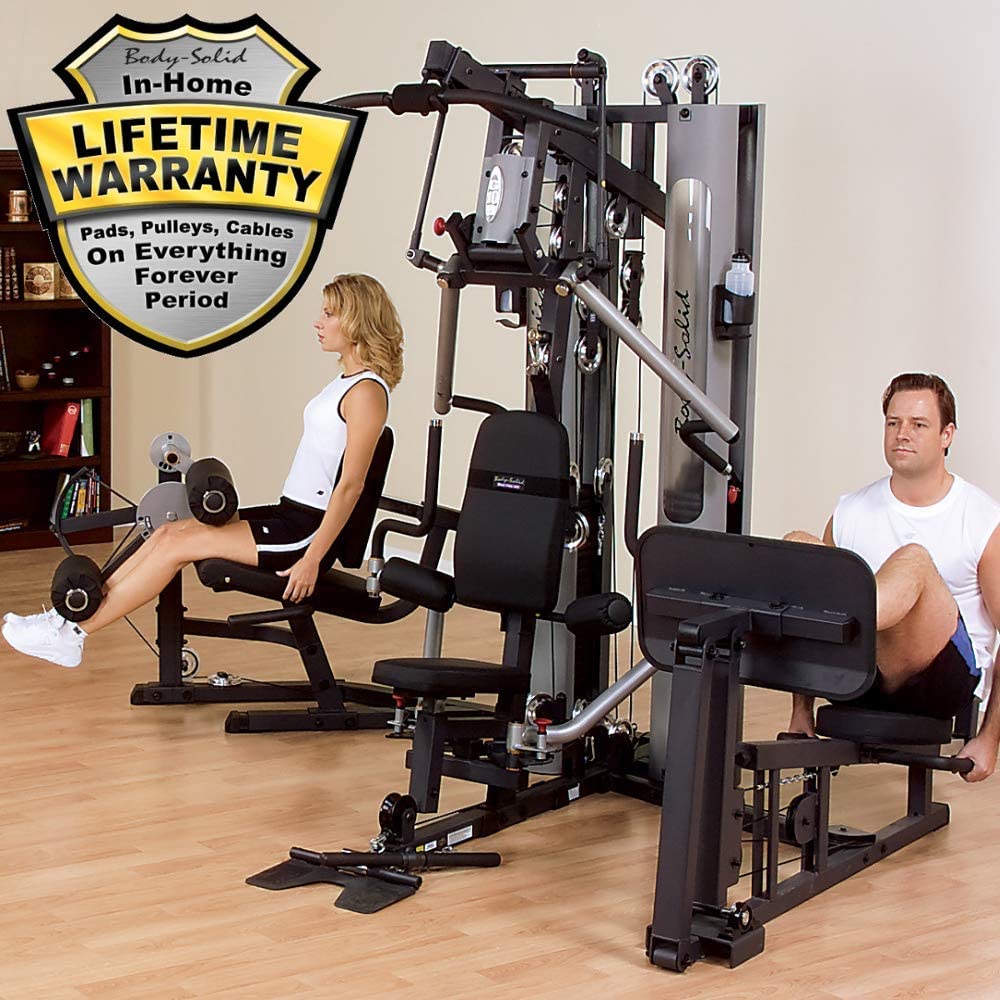 man and woman using the leg stations on the body solid g10b-lp
