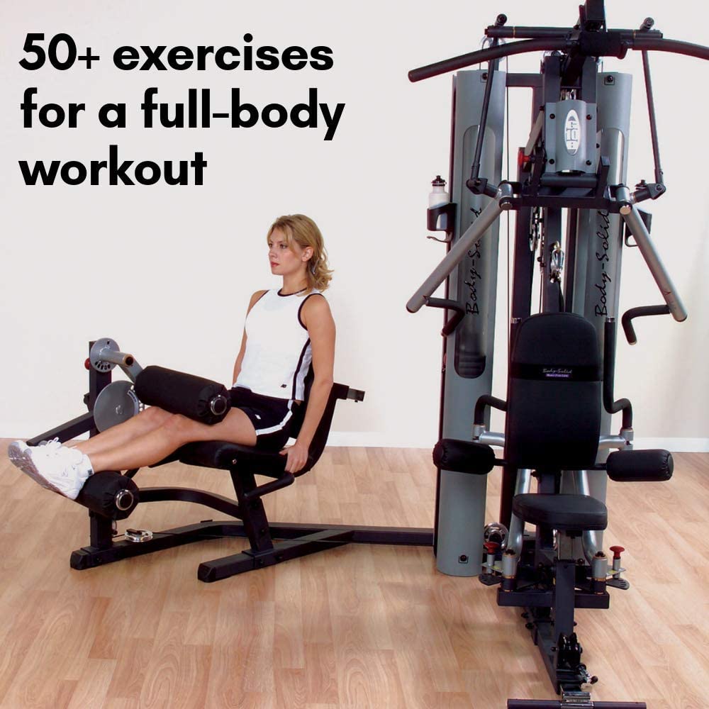 woman doing leg extensions on body solid g10b home gym