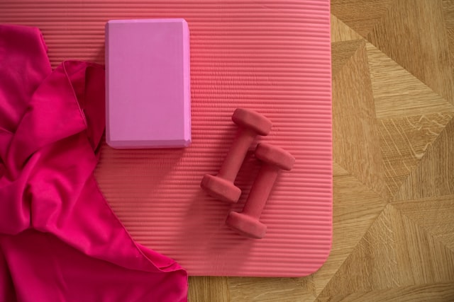 pink gym towel, pink yoga mat, pink dumbbells, and pink yoga blockr