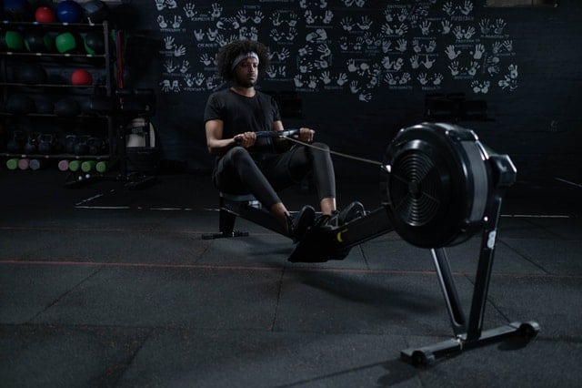 man using a concept 2 rowing machine