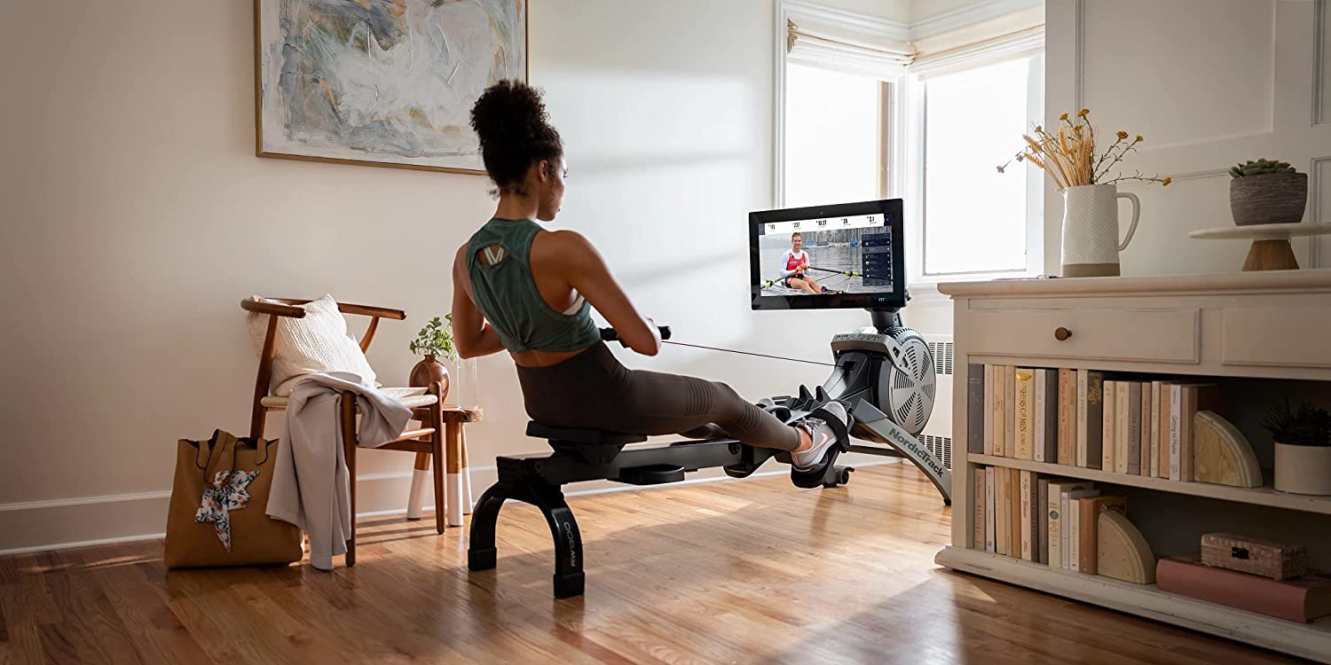 Woman Exercising on a Rowing Machine at Home