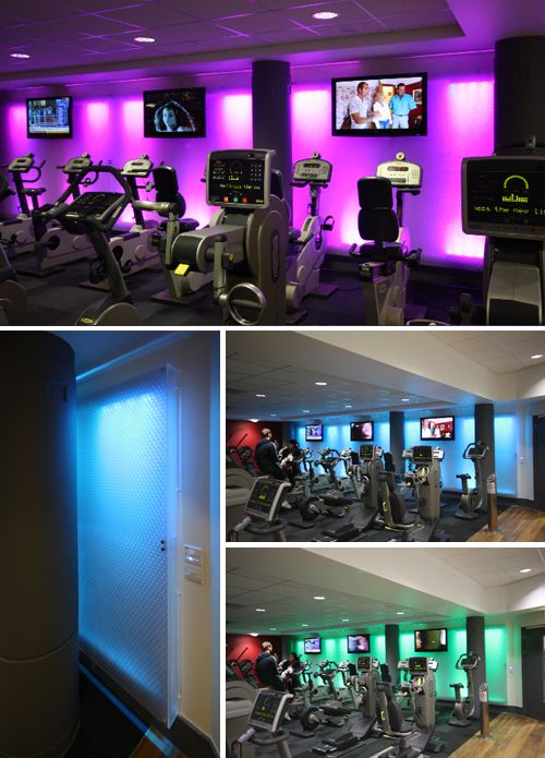 home gym with spin bikes and bright recessed LED lights