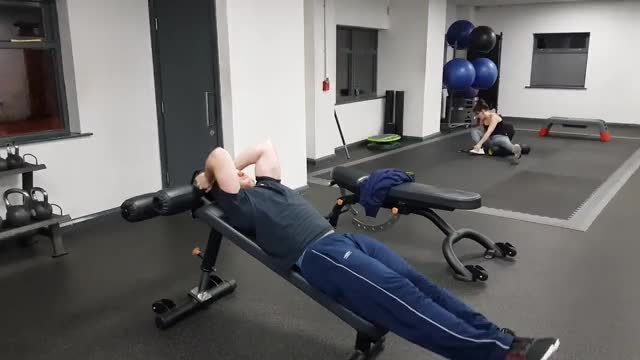 Man Doing Decline Leg Raise Exercise