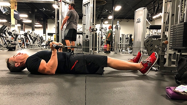 Man Doing Floor Cable Curls