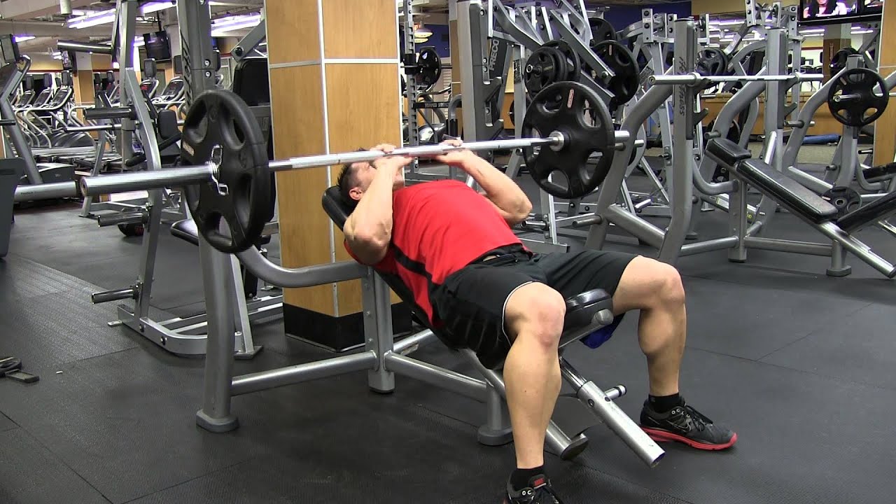 Man Doing Incline Close Grip Bench Press In The Gym