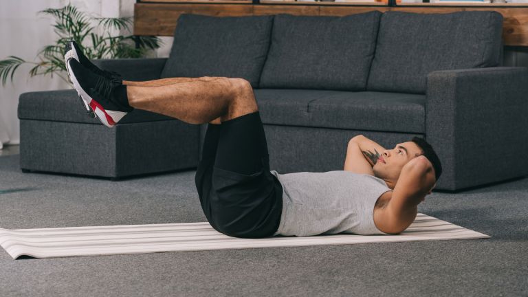 Man Doing Reverse Crunches At Home