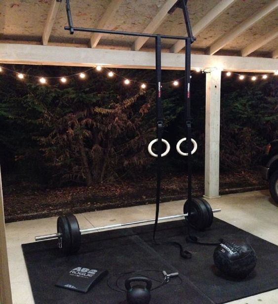 outdoor home gym with gymnastics rings and barbell