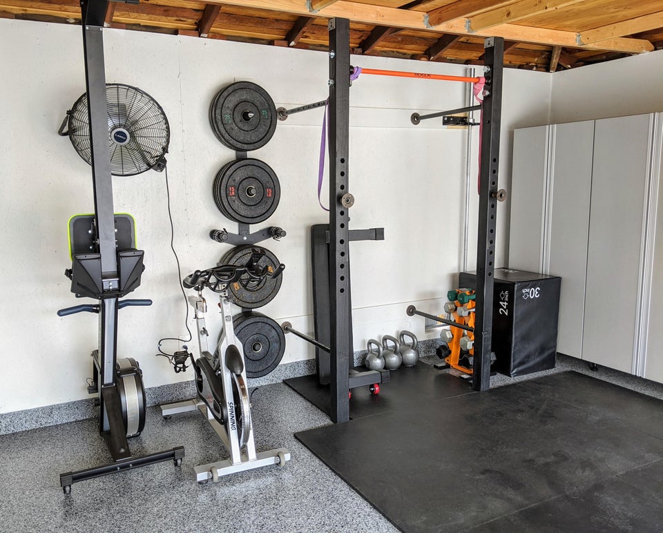 garage gym with prx performance equipment stored on the wall