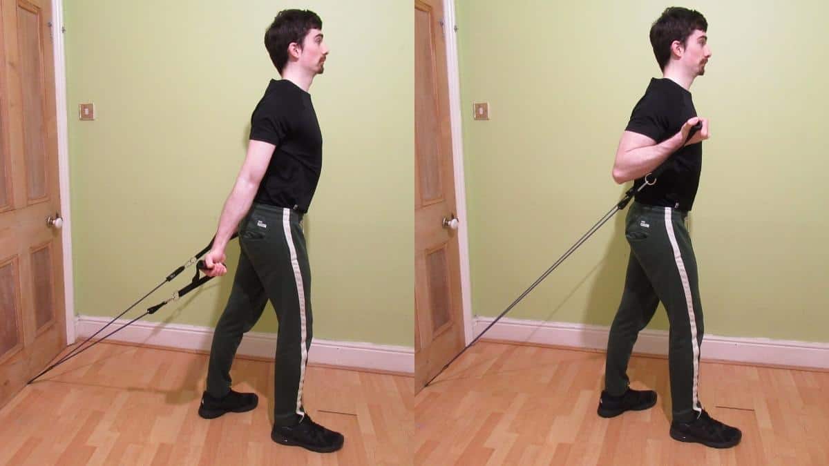 Man Doing Resistance Band Curls Exercise At Home