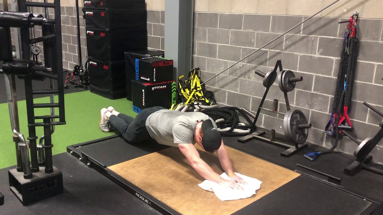 Man Doing Towel Rollout Exercise In The Gym