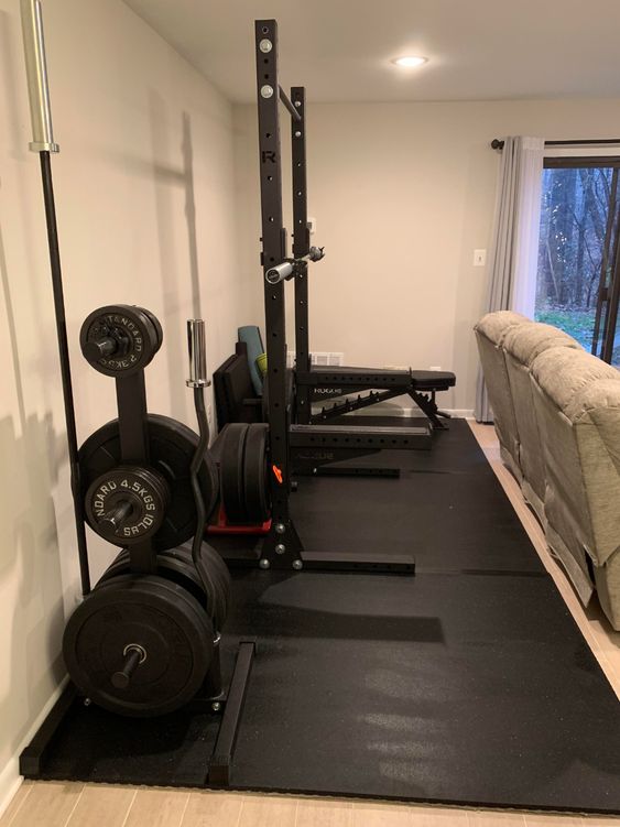 indoor living room home gym with squat rack and weight bench