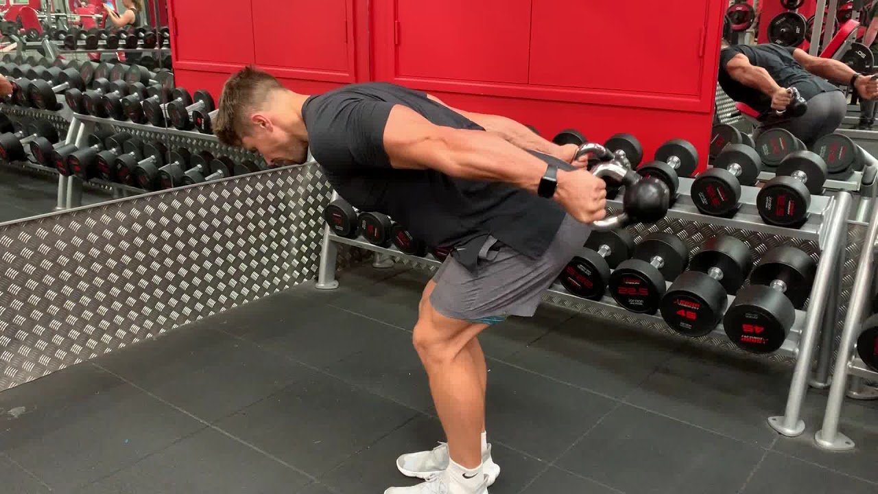 Man Doing Kettlebell Tricep Kickbacks In The Gym