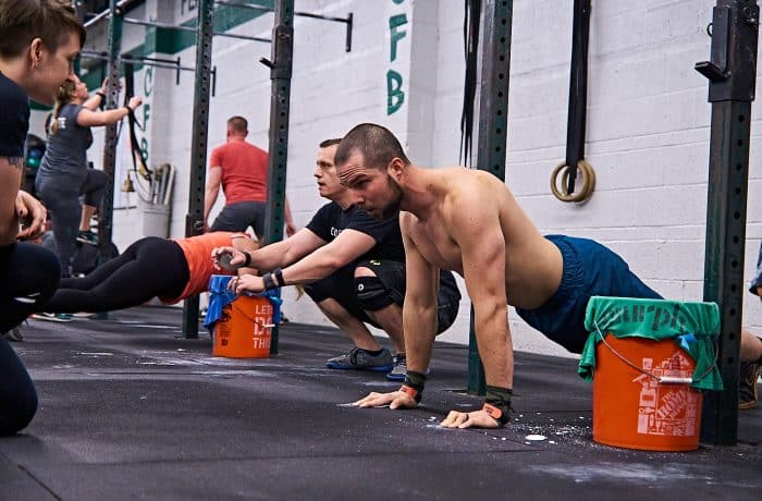 Man Doing Push Ups at a Crossfit Gym
