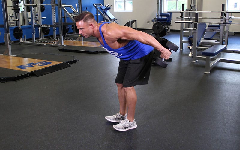 Man Doing Triceps Dumbbell Kickback In The Gym