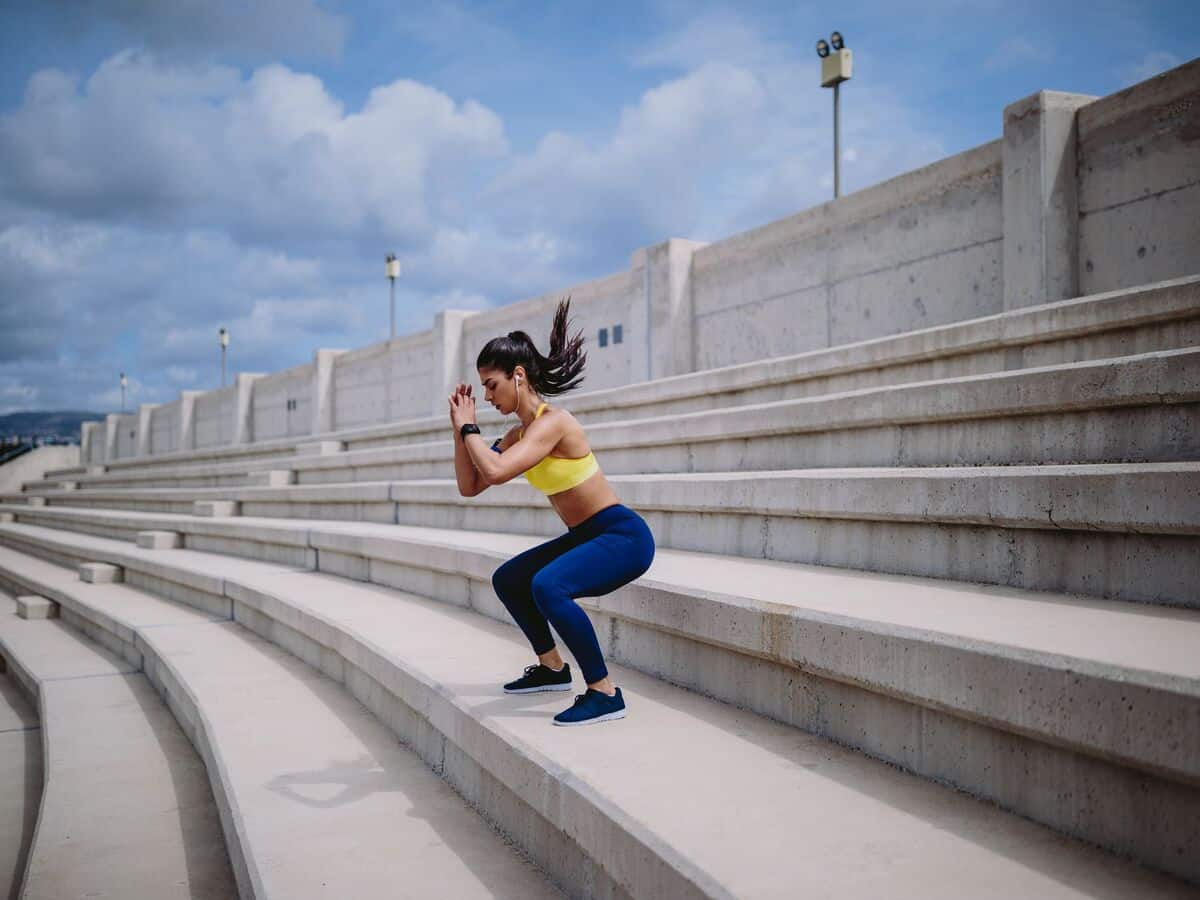 Woman Doing Squat Jumps Outdoors