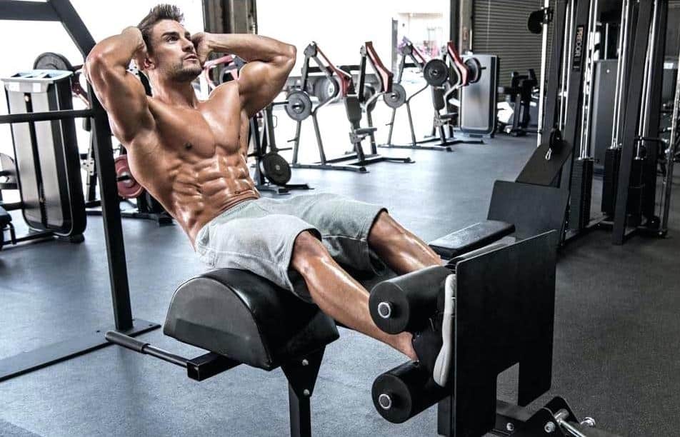 Man Doing Roman Chair Sit-Up Exercise At The Gym