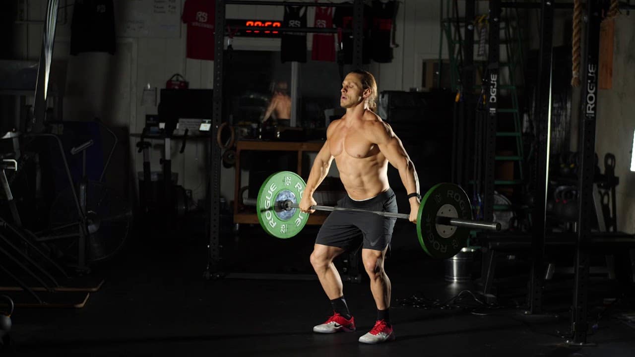 man doing hang muscle snatch with loaded barbell