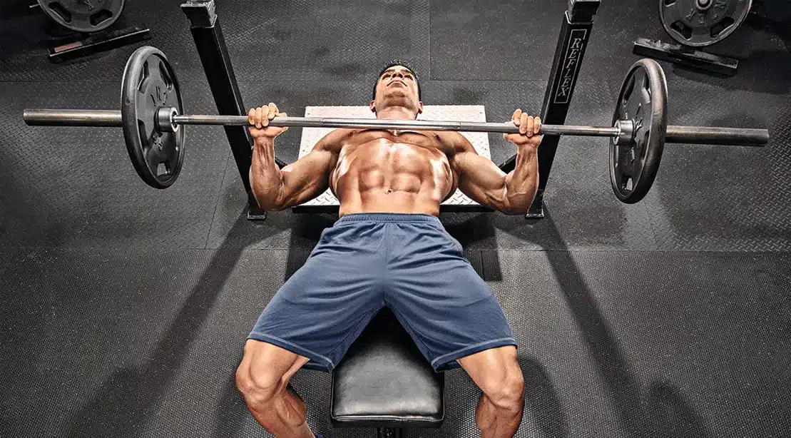 athlete doing a barbell flat bench press